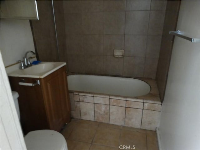 bathroom featuring tile patterned flooring, toilet, and vanity