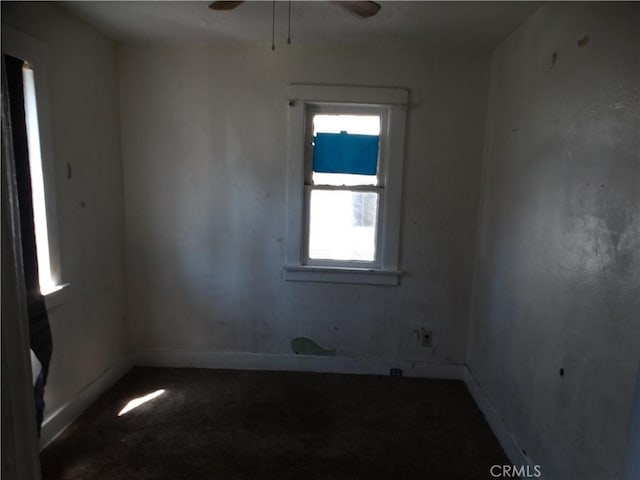 unfurnished room with carpet, baseboards, and a ceiling fan