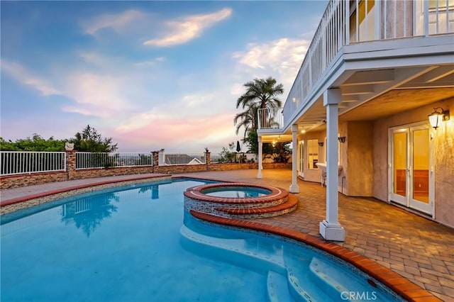 3808 E Summitridge Ln, Orange, CA 92867 - pool at dusk featuring fence, a patio, french doors, and a pool with connected hot tub