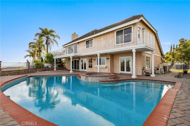 3808 E Summitridge Ln, Orange, CA 92867 - back of house with french doors, a balcony, a fenced backyard, and a chimney