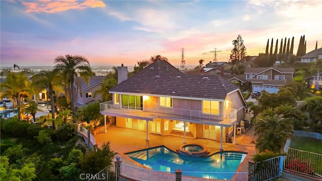 3808 E Summitridge Ln, Orange, CA 92867 - back of house at dusk with a balcony, a fenced backyard, a chimney, and a patio area
