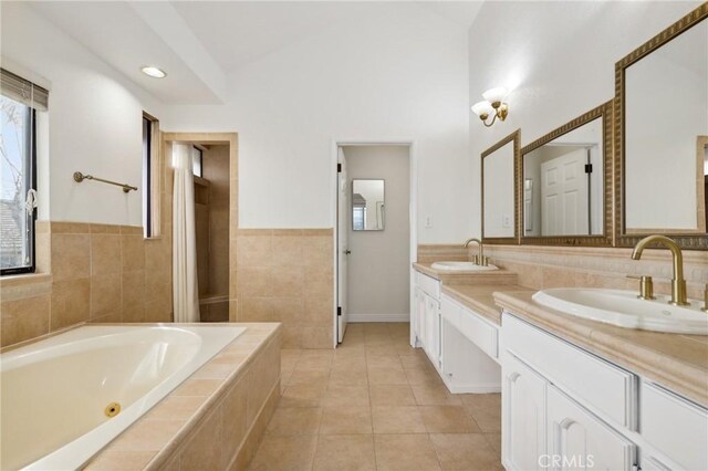 3808 E Summitridge Ln, Orange, CA 92867 - full bathroom featuring double vanity, a bath, tile walls, lofted ceiling, and tile patterned flooring