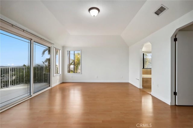 3808 E Summitridge Ln, Orange, CA 92867 - spare room featuring plenty of natural light, wood finished floors, arched walkways, baseboards, and lofted ceiling