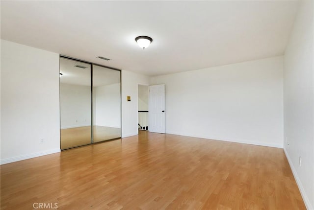3808 E Summitridge Ln, Orange, CA 92867 - unfurnished bedroom featuring light wood-style flooring, baseboards, a closet, and elevator