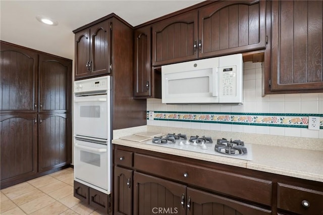3808 E Summitridge Ln, Orange, CA 92867 - kitchen with white appliances, light countertops, decorative backsplash, dark brown cabinets, and light tile patterned floors