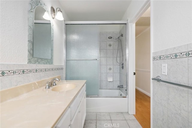 3808 E Summitridge Ln, Orange, CA 92867 - bathroom with tile walls, enclosed tub / shower combo, tile patterned flooring, vanity, and wainscoting