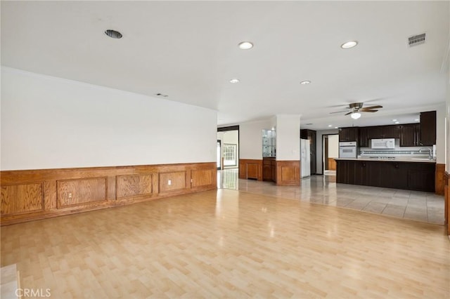 3808 E Summitridge Ln, Orange, CA 92867 - empty room featuring a sink, recessed lighting, light wood-style flooring, ceiling fan, and a wainscoted wall