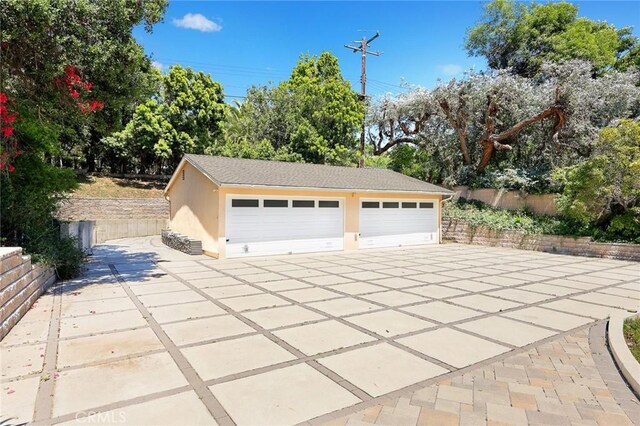 detached garage featuring fence