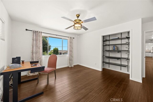 office space with ceiling fan, wood finished floors, and baseboards