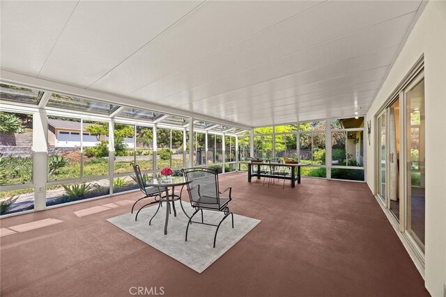 sunroom with outdoor dining area