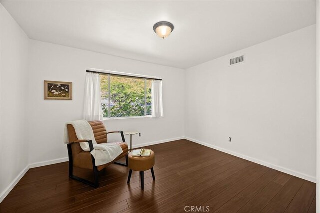 living area with dark wood finished floors and baseboards