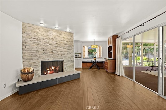 living area featuring dark wood-type flooring, a fireplace, and french doors