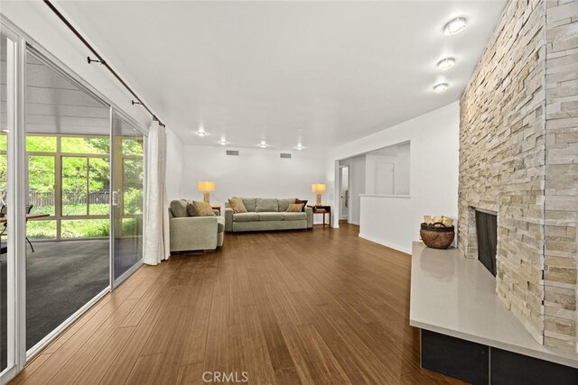 living area featuring a fireplace and wood finished floors