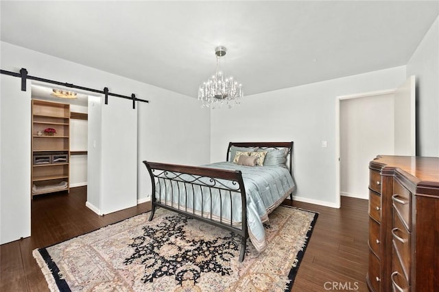 152 Spinks Canyon Rd, Bradbury, CA 91008 - bedroom with a barn door, dark wood-style flooring, a chandelier, and a walk in closet