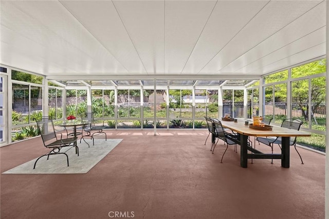 sunroom featuring healthy amount of natural light and outdoor dining space