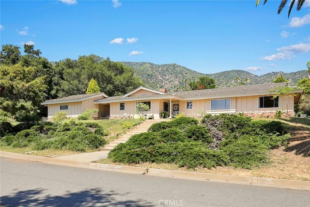 152 Spinks Canyon Rd, Bradbury, CA 91008 - single story home with board and batten siding, a mountain view, stairway, and stone siding