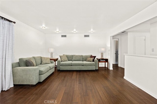 living room featuring dark wood finished floors and baseboards