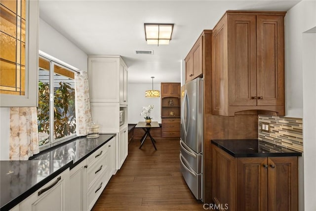 152 Spinks Canyon Rd, Bradbury, CA 91008 - kitchen with freestanding refrigerator, dark countertops, tasteful backsplash, brown cabinets, and dark wood-style floors