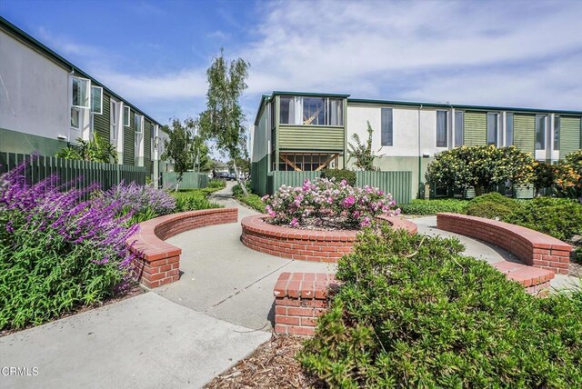 view of home's community featuring fence