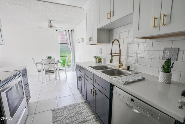 kitchen with dishwashing machine, a sink, stainless steel electric stove, tasteful backsplash, and a ceiling fan