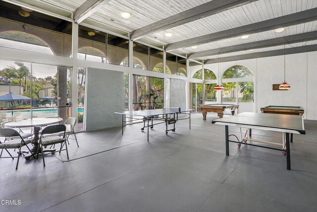 game room featuring billiards, concrete flooring, and beam ceiling