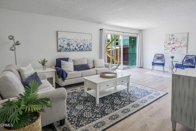 living area featuring wood finished floors and a textured ceiling