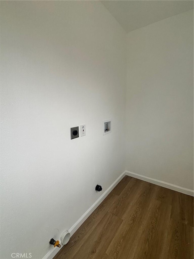 washroom featuring washer hookup, dark wood-style floors, electric dryer hookup, and baseboards