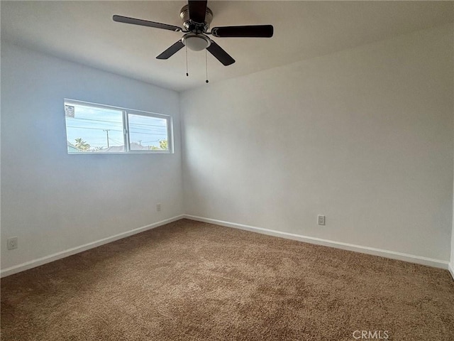 empty room featuring carpet floors, baseboards, and a ceiling fan