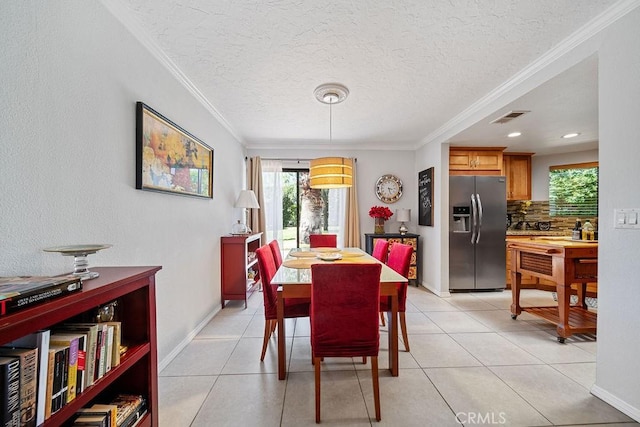 3155 E Ramon Rd Unit 607, Palm Springs, CA 92264 - dining area with plenty of natural light, ornamental molding, a textured ceiling, baseboards, and light tile patterned flooring