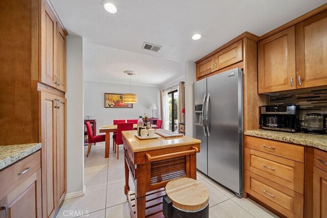 3155 E Ramon Rd Unit 607, Palm Springs, CA 92264 - kitchen featuring stainless steel fridge with ice dispenser, brown cabinetry, light tile patterned floors, decorative backsplash, and recessed lighting