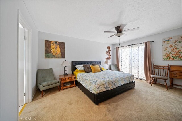 3155 E Ramon Rd Unit 607, Palm Springs, CA 92264 - bedroom with light carpet, a ceiling fan, and a textured ceiling
