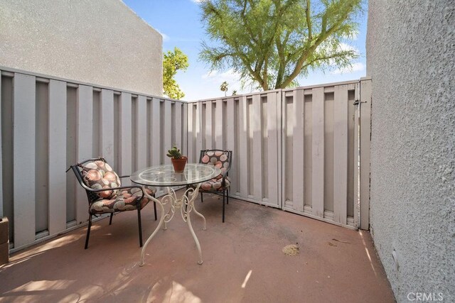 3155 E Ramon Rd Unit 607, Palm Springs, CA 92264 - view of patio / terrace with outdoor dining space and fence