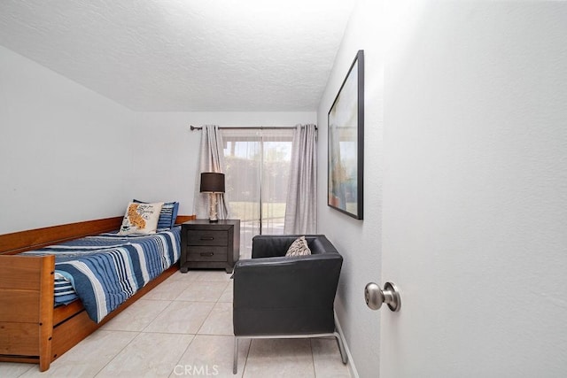 3155 E Ramon Rd Unit 607, Palm Springs, CA 92264 - bedroom featuring baseboards, a textured ceiling, and light tile patterned floors