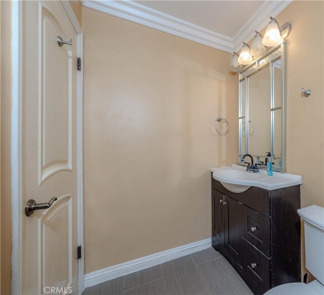 6371 Shawnee Rd, Westminster, CA 92683 - bathroom featuring vanity, baseboards, toilet, and ornamental molding