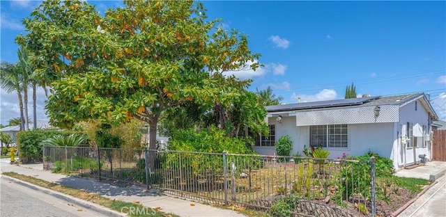 6371 Shawnee Rd, Westminster, CA 92683 - view of front of property with roof mounted solar panels and stucco siding