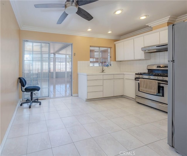 6371 Shawnee Rd, Westminster, CA 92683 - kitchen featuring stainless steel range with gas cooktop, freestanding refrigerator, under cabinet range hood, light countertops, and white cabinets