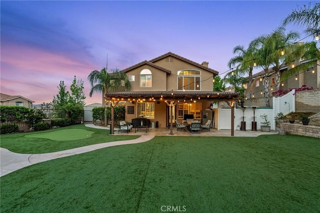 30463 Vineyard Ln, Castaic, CA 91384 - rear view of house with an area to practice putting, a patio area, stucco siding, and a tiled roof