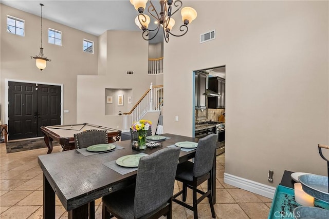 30463 Vineyard Ln, Castaic, CA 91384 - dining room with stairs, a high ceiling, a chandelier, baseboards, and light tile patterned flooring