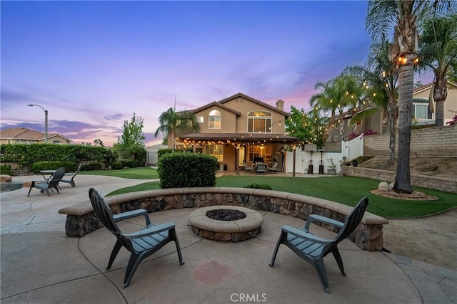 30463 Vineyard Ln, Castaic, CA 91384 - patio terrace at dusk with an outdoor fire pit and a patio area