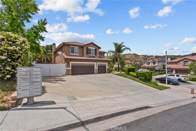 30463 Vineyard Ln, Castaic, CA 91384 - view of front of property featuring a tiled roof, an attached garage, stucco siding, driveway, and a gate