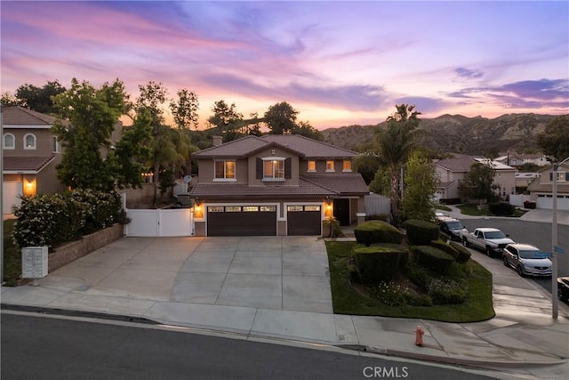 30463 Vineyard Ln, Castaic, CA 91384 - traditional-style house featuring a tile roof, an attached garage, a gate, driveway, and a mountain view