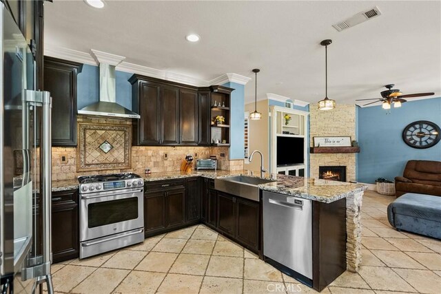 30463 Vineyard Ln, Castaic, CA 91384 - kitchen featuring appliances with stainless steel finishes, wall chimney range hood, open floor plan, a sink, and open shelves