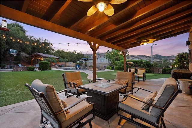 30463 Vineyard Ln, Castaic, CA 91384 - patio terrace at dusk featuring a fire pit, ceiling fan, and a patio