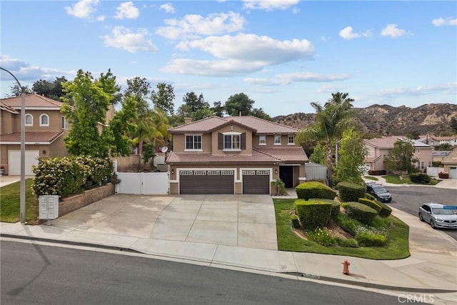 30463 Vineyard Ln, Castaic, CA 91384 - traditional home featuring a tile roof, an attached garage, driveway, stucco siding, and a gate