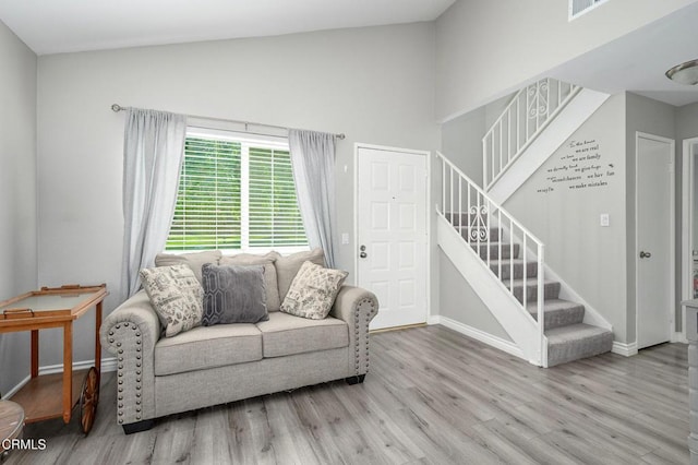 14886 Reedley St Unit A, Moorpark, CA 93021 - living area featuring stairway, wood finished floors, and high vaulted ceiling