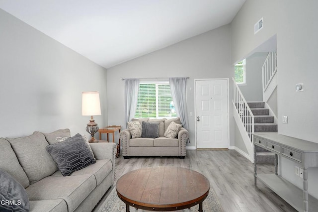 14886 Reedley St Unit A, Moorpark, CA 93021 - living room featuring light wood finished floors, stairway, and high vaulted ceiling