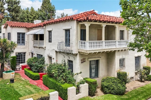 4235 Garthwaite Ave, Los Angeles, CA 90008 - mediterranean / spanish-style house with a balcony, stucco siding, and a tiled roof
