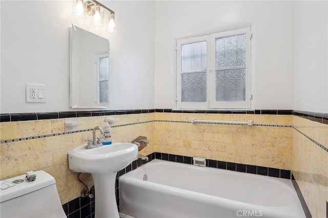 4235 Garthwaite Ave, Los Angeles, CA 90008 - full bathroom with toilet, wainscoting, tile walls, and a tub