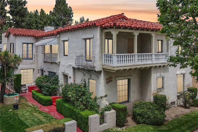 4235 Garthwaite Ave, Los Angeles, CA 90008 - mediterranean / spanish home featuring a balcony, stucco siding, and a tiled roof