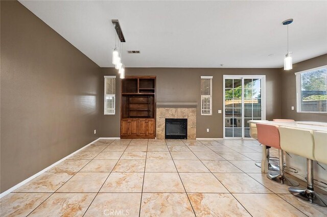 14271 Blackstone St, Hesperia, CA 92345 - living area featuring a tile fireplace, light tile patterned floors, and baseboards